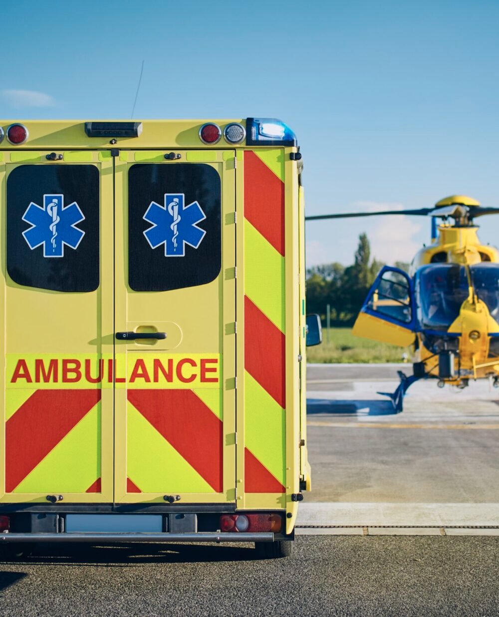Emergency Medical Service Ambulance car against helicopter of emergency medical service. Themes rescue, help and hope.